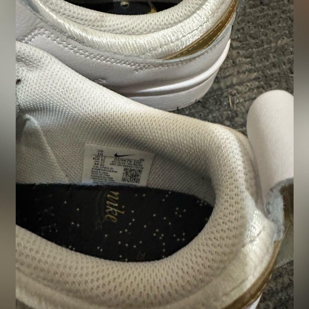 air force  ones white with gold swoosh symbol